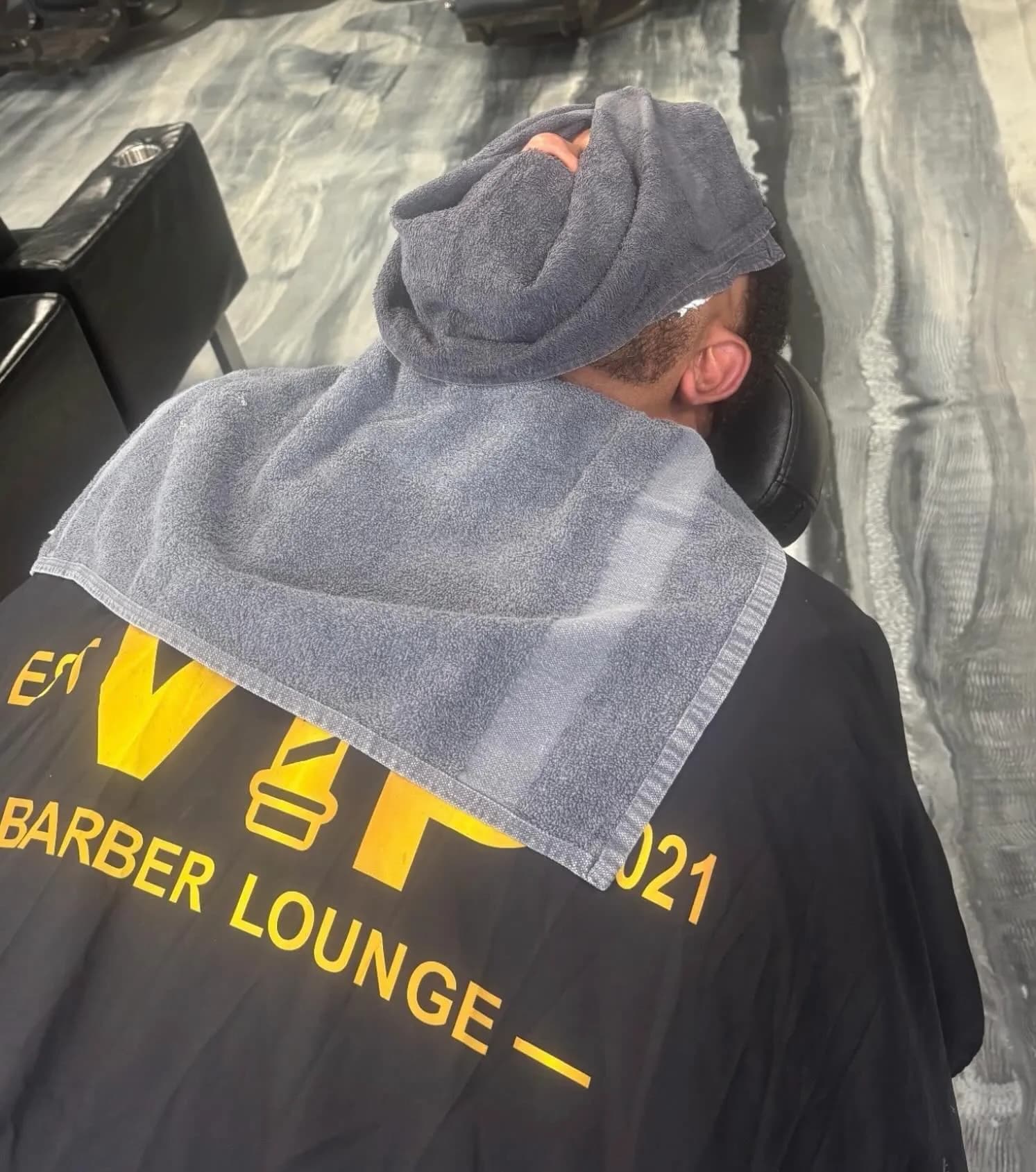 Hot towel treatment in a VIP Barber Lounge cape at VIP Barber Lounge, Denver & Aurora