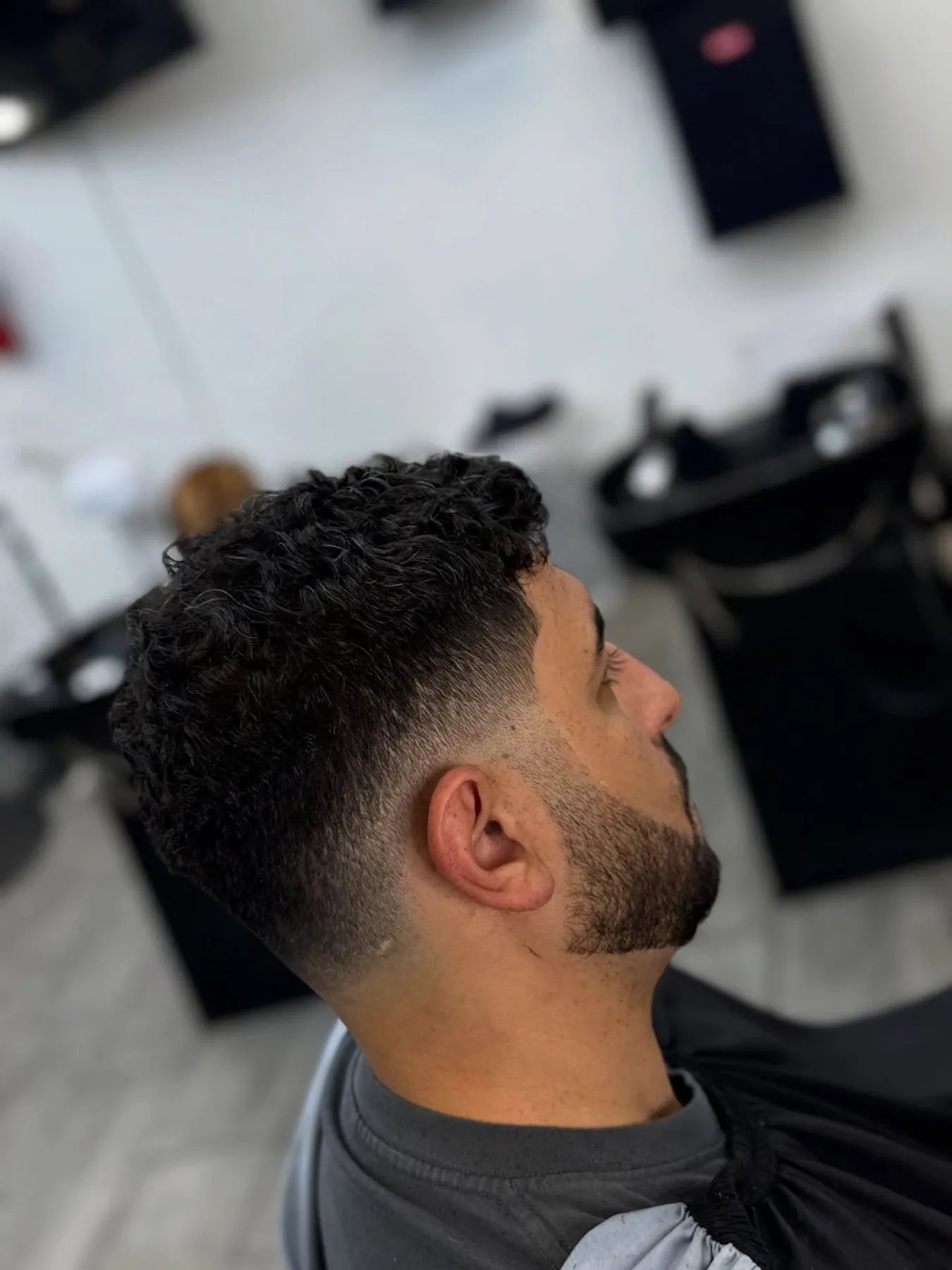 Curly taper with a full beard at VIP Barber Lounge, Denver & Aurora