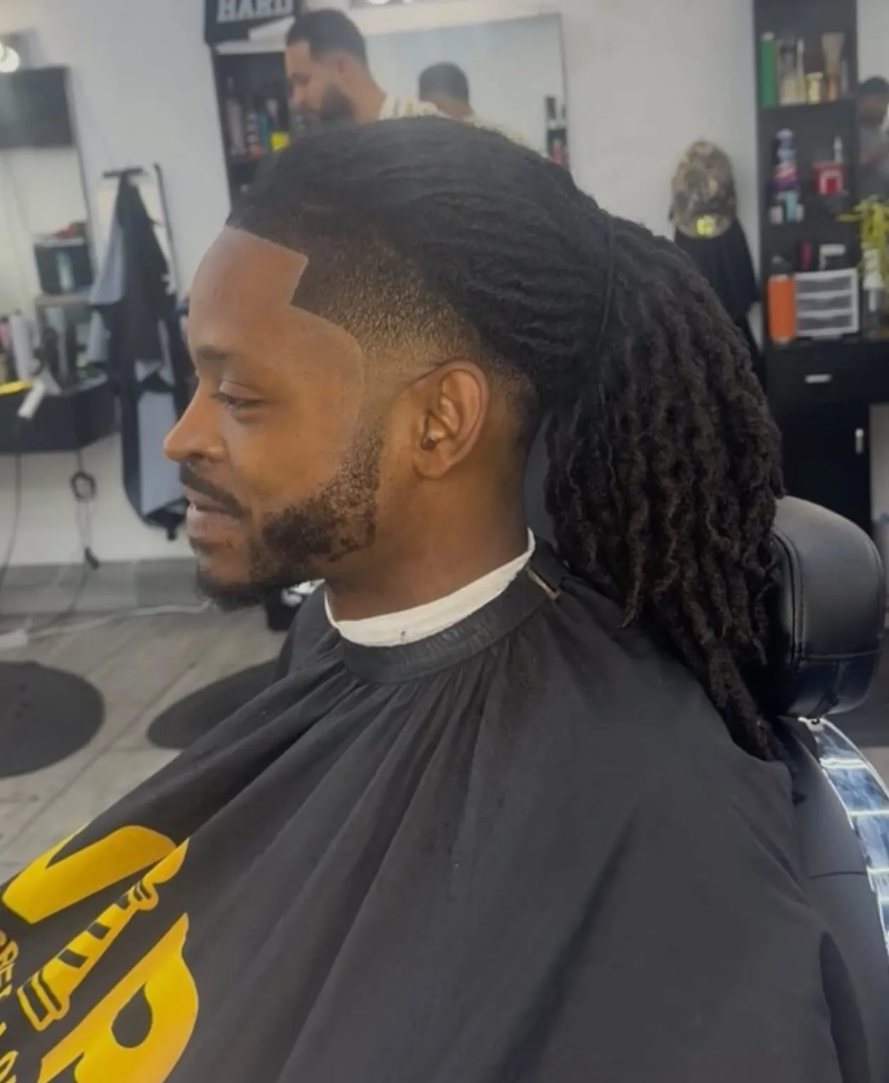 Locs with a lined-up edge and beard at VIP Barber Lounge, Denver & Aurora