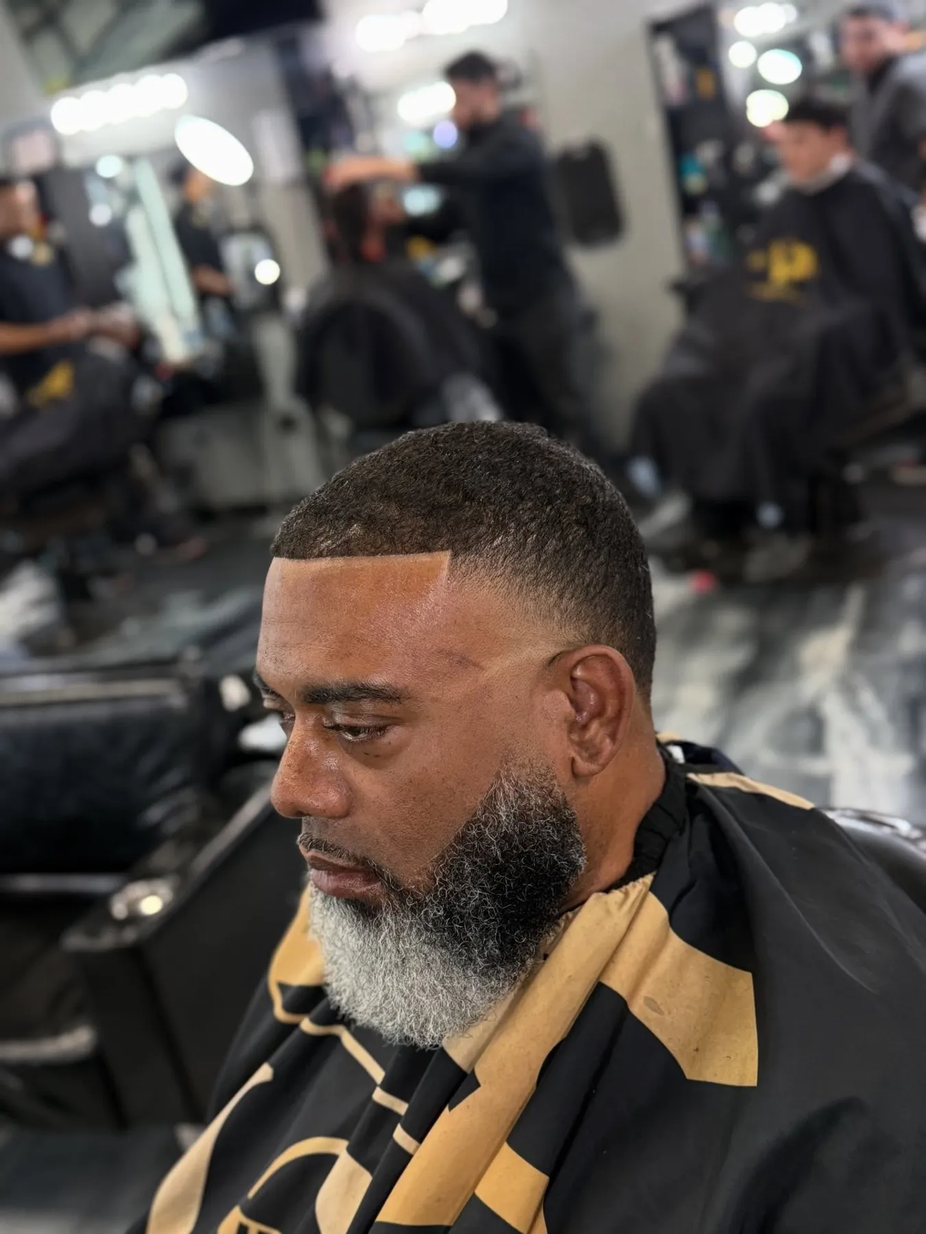 Haircut and beard lineup on a salt-and-pepper beard at VIP Barber Lounge, Denver & Aurora