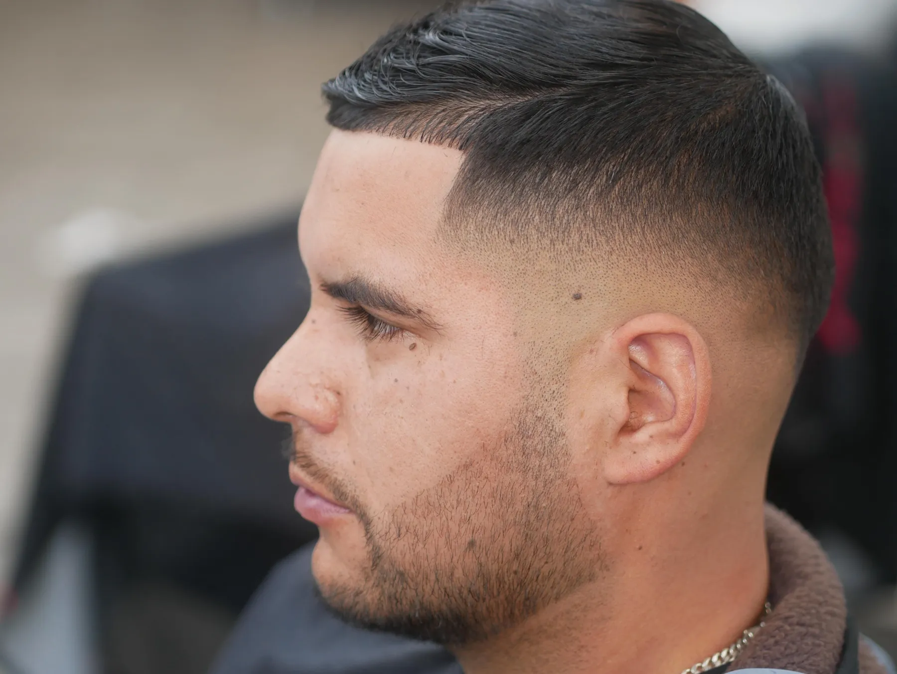 Classic short side part with a clean taper at VIP Barber Lounge, Denver & Aurora