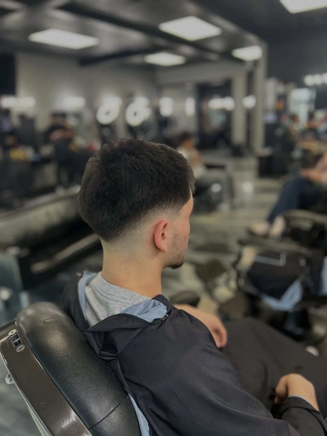 Low taper fade with a textured fringe at VIP Barber Lounge, Denver & Aurora
