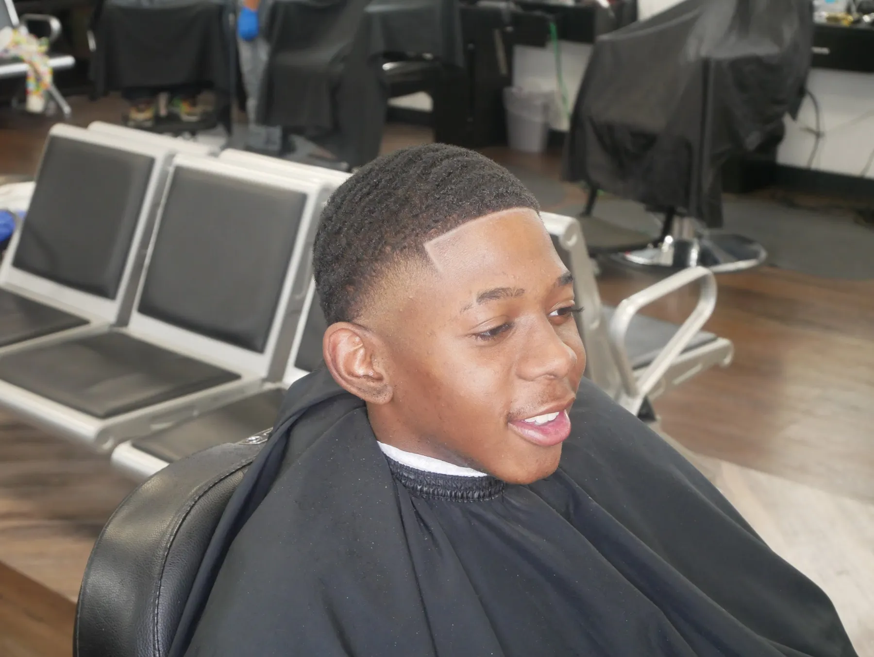 Smiling young client after a fresh kids' fade at VIP Barber Lounge Aurora