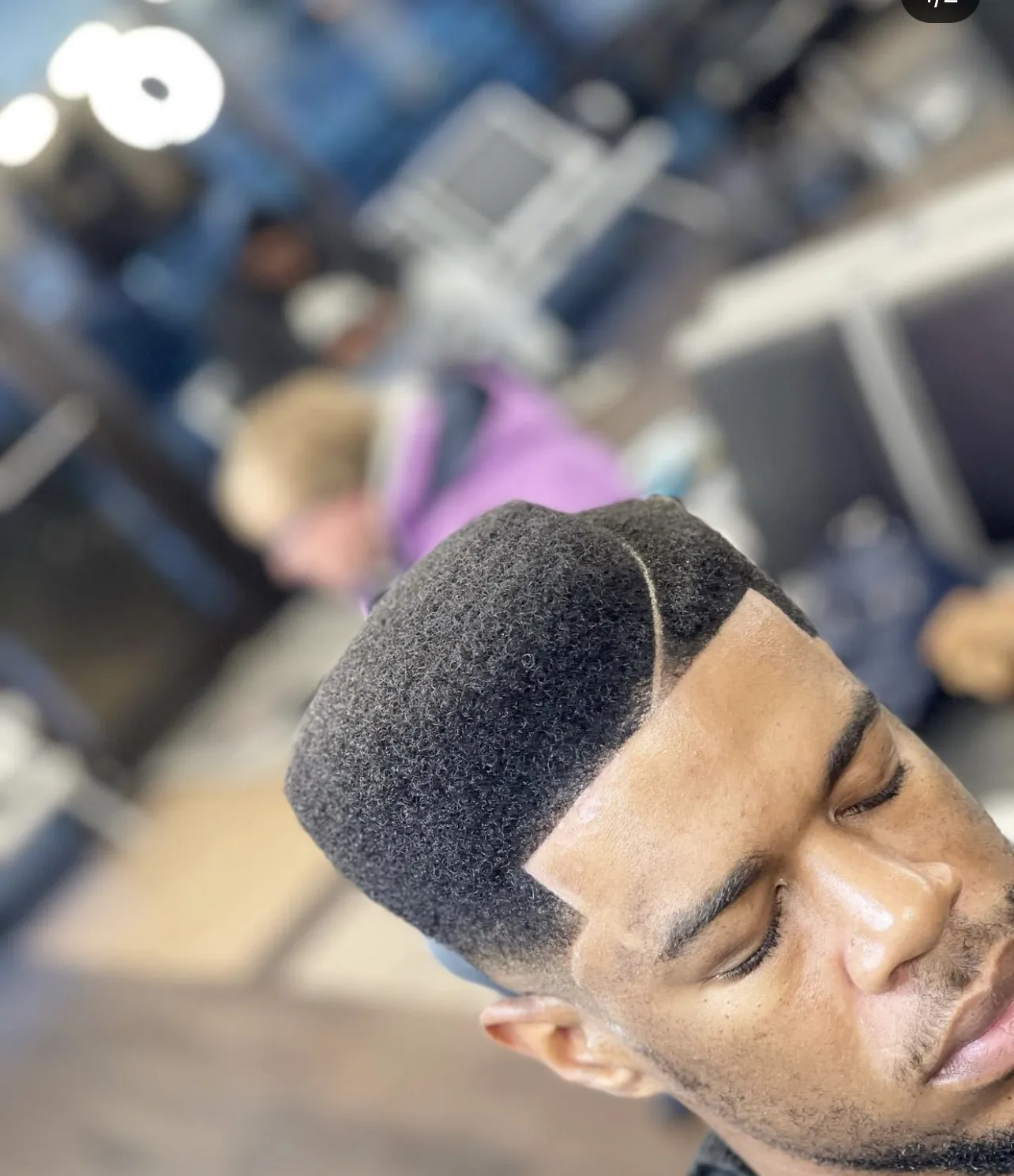 High-top fade with a hard part at VIP Barber Lounge Denver