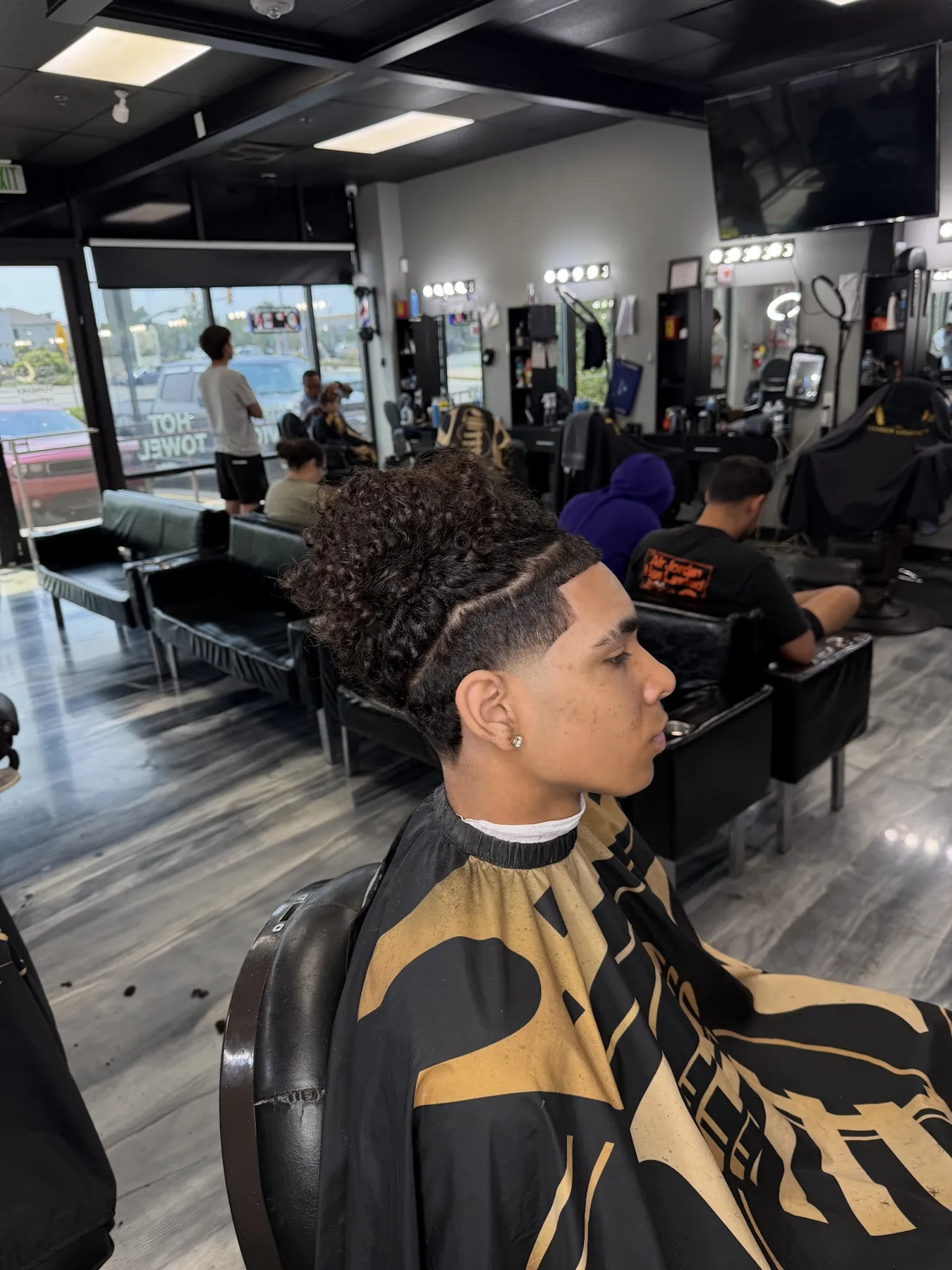 Curly top with a taper fade at VIP Barber Lounge South Aurora