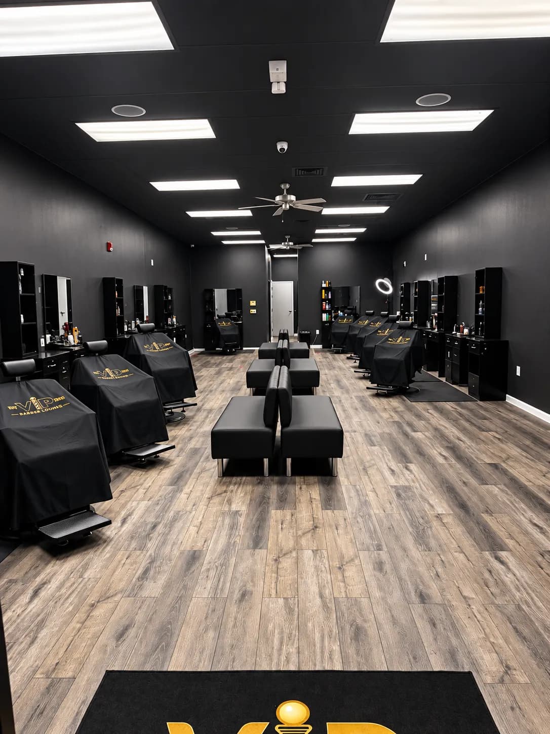 Black barber chairs and mirror stations inside VIP Barber Lounge South Aurora