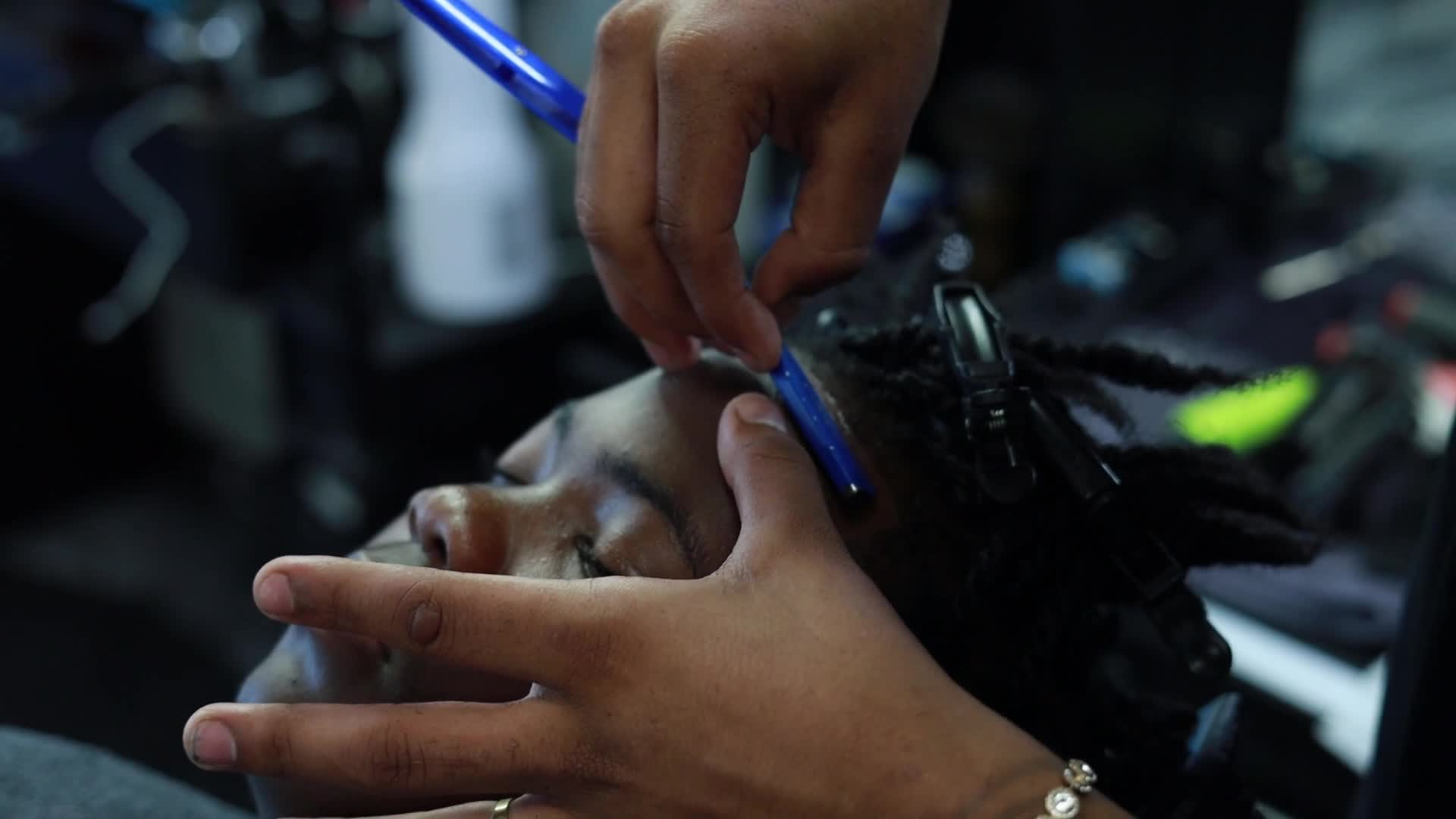 Barber detailing a fresh cut at VIP Barber Lounge